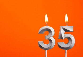 Candle number 35 - Birthday in orange background