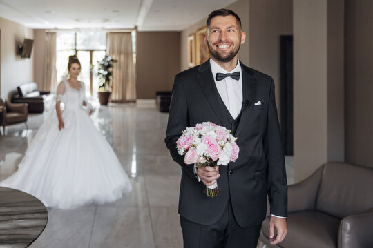 First look of wedding couple in the morning. Wedding couple in the loft studio. Bride and groom. The first meeting of the bride and groom. Happy bride