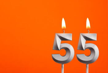 Candle number 55 - Birthday in orange background