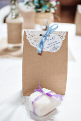 Fototapeta na wymiar a brown paper package, with a white lace detail and blue ribbon