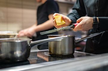 Chef hands cooking sauce in the restaurant kitchen
