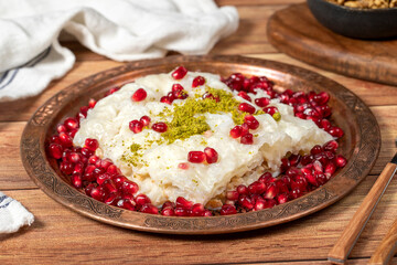 Gullac dessert. Milky dessert made special for the month of Ramadan. Traditional Turkish cuisine delicacies. gullac dessert on a copper plate