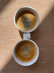 two cups of coffee on table forming infinity sign
