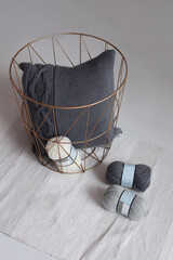 Beautiful knitted light pillows and balls of thread for knitting