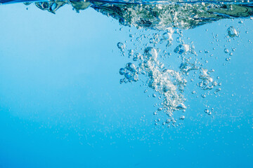 Naklejka na ściany i meble Abstract clear blue water. Splash with bubbles. Copy space