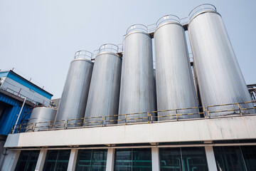 Stainless vertical steel tanks with equipment tank chemical cellar at the with stainless steel silo