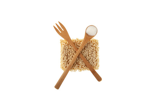 Dry pressed instant noodles are abstractly crossed out with fork and spoon. Fast food concept, food additive, monosodium glutamate, E627, E631 and others