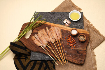 Marinated raw chicken skewers, seasoning on wood board, prepare for the grill and BBQ