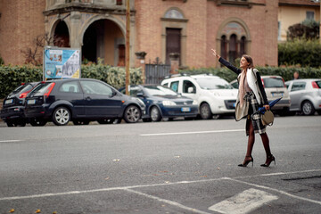 Businesswoman on the street stops taxi