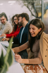 Happy brunette businesswoman having a business meeting on her tablet