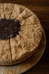 Close-up shot of a walnut cheesecake with cinnamon on a wooden table