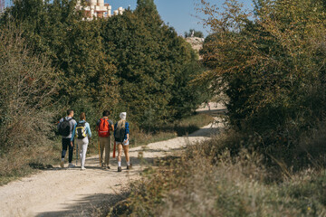 Obraz premium A full length photo of two hiking couples walking off road
