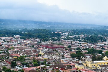 Obraz premium Top view of the densely populated cityscape of Antigua with similar residential buildings, Guatemala