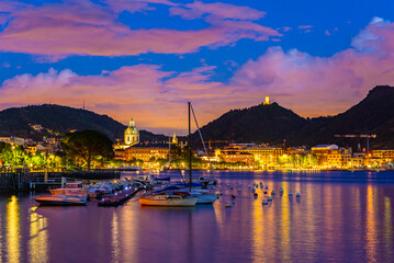 The city of Como, photographed in the evening, with the lakefront, the cathedral, and the...