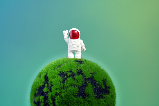 Funny astronaut  on a green planet