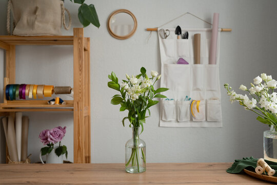 Glass vase with bouquet of white flowers