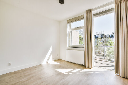 Interior of empty room with window and curtains