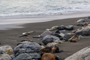 The rocky California coastline as off the Pacific Coast Highway near the Big Sur area. Classic foggy conditions and rough waters.