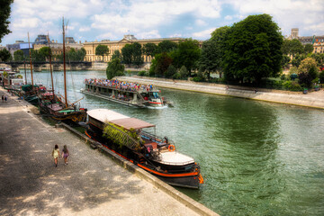 Naklejka premium Boats on the River Seine in Paris, France, on a Summer Day