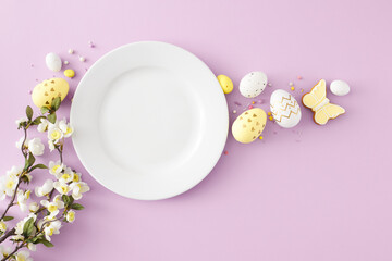 Obraz na płótnie Canvas Easter decor concept. Top view photo of empty white plate colorful easter eggs sprinkles gingerbread and cherry blossom branch on pastel violet background