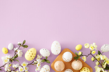 Fototapeta na wymiar Easter celebration idea. Flat lay photo of white yellow and golden easter eggs in wooden holder and spring blossom flowers on pastel violet background with copyspace