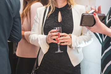 Woman standing with a glass of champagne in the event hall