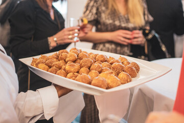 Waiter serving snacks to the guests