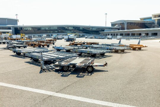 Airport Malpensa in Milan with the carts and passenger planes preparing for flight