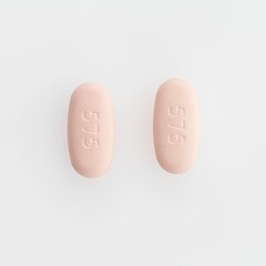 Closeup shot of two oval medical pills isolated on a white background