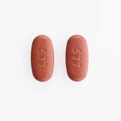 Closeup shot of two oval medical pills isolated on a white background