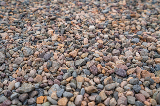Scenic tiny asymmetric pebbles on the ground, cool for background