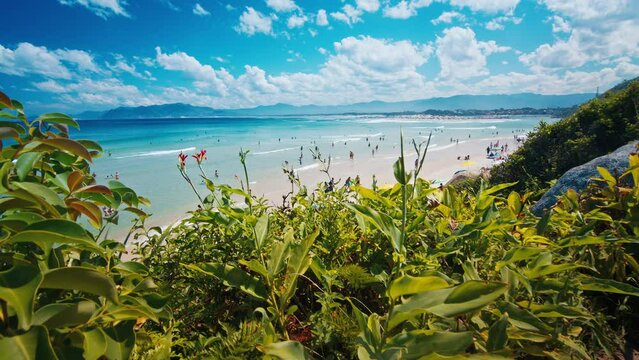 People relax on the perfect sandy beach near the town of Guarda Do Embau in the state of Santa Catarina in Brazil