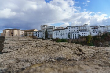 view of the buildings on the edge of the cliff of tajo de ronda , malaga spain