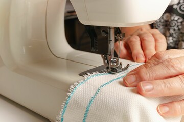 woman's hands sewing fabric on a sewing machine