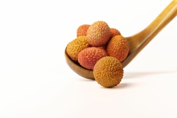 fresh lychees in a wooden spoon