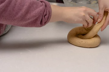 Zelfklevend Fotobehang woman kneading fresh dough for making cookies © Jose Antona/Wirestock Creators