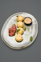 cheesecakes with meat.and microgreens