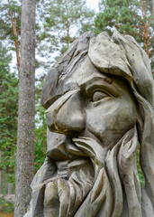 Fototapeta na wymiar KEMEROVO, RUSSIA - AUGUST 19, 2022: A fragment of a wooden sculpture of a forest deity in the Siberian forest