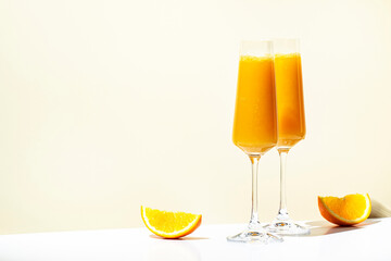 Mimosa alcohol cocktail drink with orange juice and cold dry champagne or sparkling wine in...