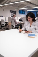 Young employees working and taking notes in the office