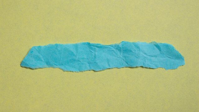 Creased Blue Paper Piece On A Yellow Background. Crumpled Torn Paper Edge Texture Background. Design Elements For Your Projects.