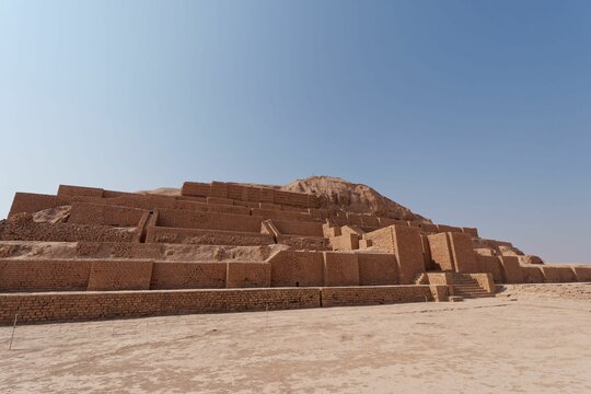 Beautiful shot of the historic Ziggurat of Chogha Zanbil under a blue sky in Khuzestan, Iran