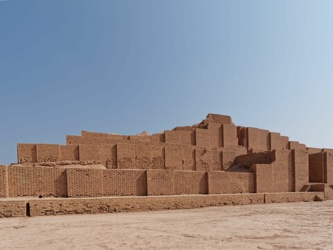 Beautiful shot of the historic Ziggurat of Chogha Zanbil under a blue sky in Khuzestan, Iran