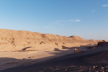 Desert under clear blue sky, serene landscape with sand dunes and no people