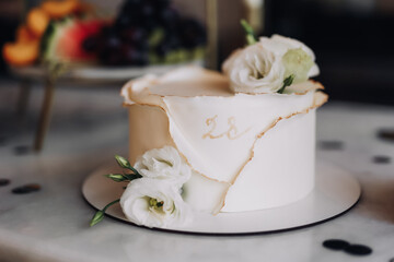 close-up of a delicate cake in powdery shades with rose flowers