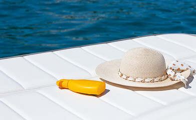 a sun hat and sun protection cream, sea vacation, travel, summer, skin health concept, sun protection, skin protection, skin cancer prevention