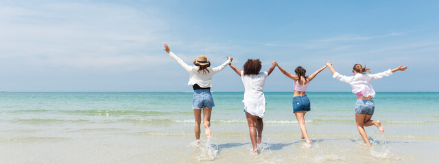 Holiday summer activity, Diverse teenage friends running into the sea. Group of friends playing on the beach. Lifestyles on vacation and holiday, Travel concept.