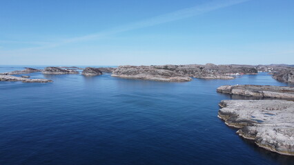 Norwegian Sea. Rocks near the sea coast. Beautiful sea water. Blue sky and nice sun rays