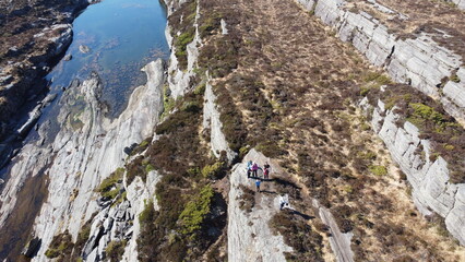 Norwegian mountains and Norwegian sea. Nature of Norway. Group of people hiking in the mountains
