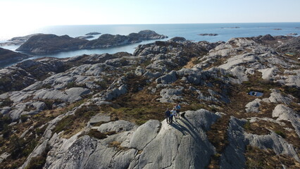 Norwegian mountains and Norwegian sea. Nature of Norway. Group of people hiking in the mountains